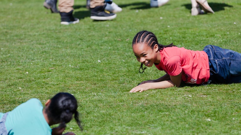 Two girls lying on the grass at Polesden Lacey, Surrey